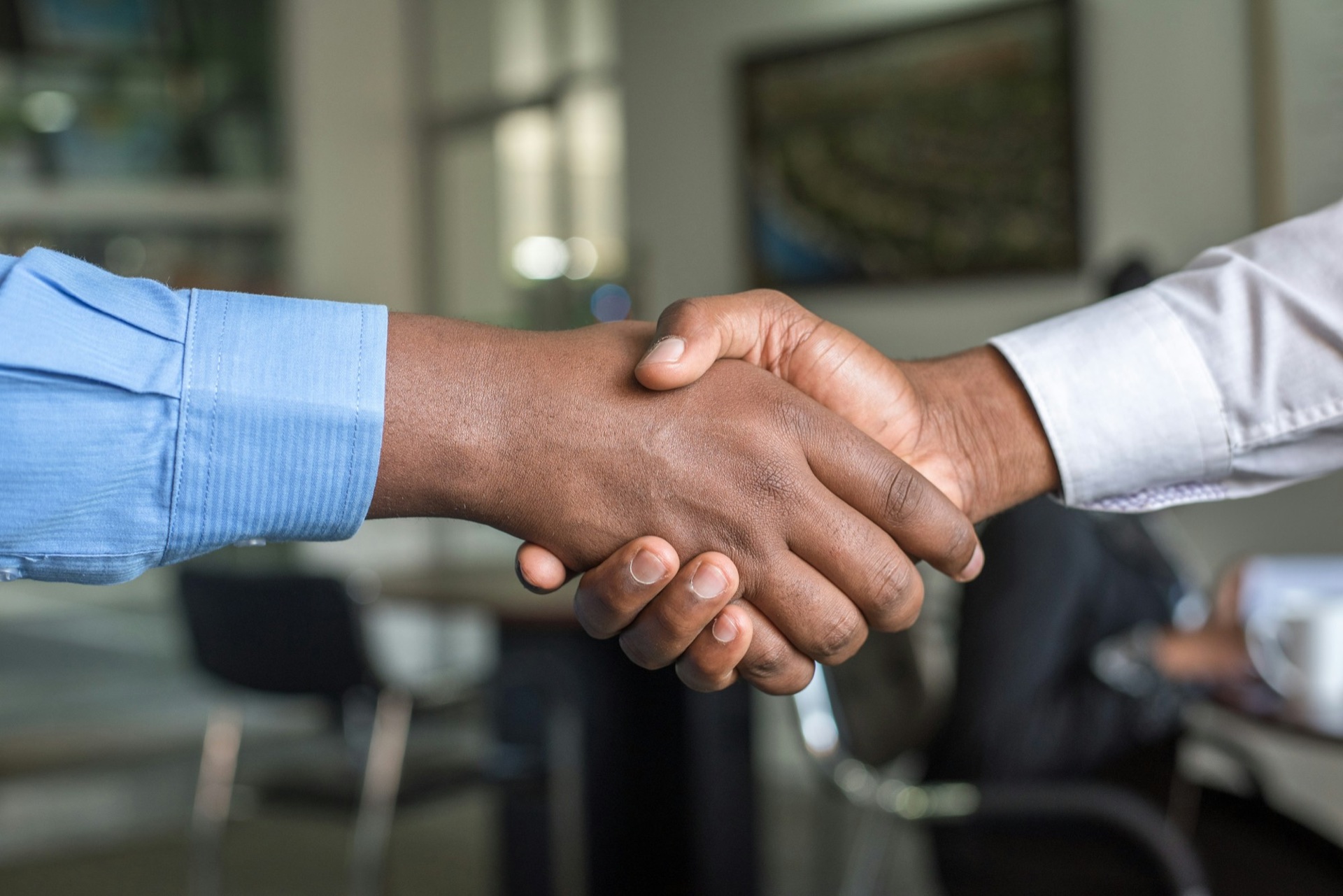 Trade decision-makers shaking hands on a deal