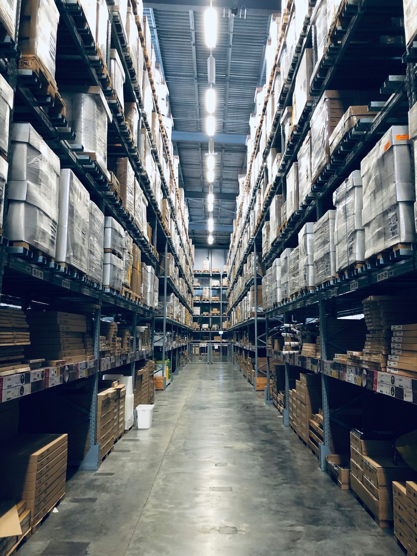 Forklift moving pallets in a procurement warehouse